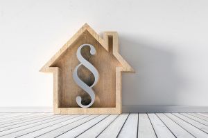 Häuschen mit Paragraf-Zeichen darin